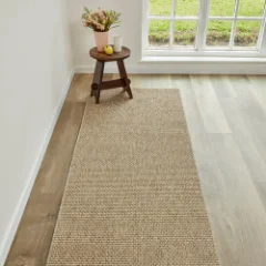 Chunky Boucle Camel rug laid as a runner beside a pale timber floor