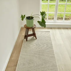 Hill n Dale Stone rug laid as a runner beside a pale timber floor