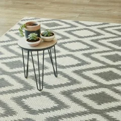 Diamond Grey outdoor rug beneath a hairpin table holding potted plants