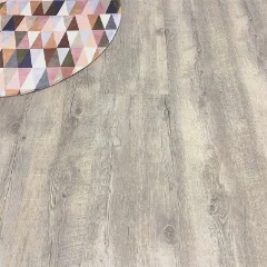 Baltic vinyl plank flooring in weathered grey-taupe, with the corner of a geometric patterned rug