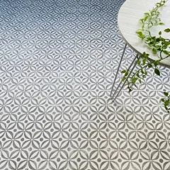 Serenity Grey vinyl flooring with a white table edge and greenery above it