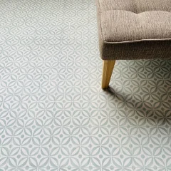 Serenity Seafoam vinyl flooring beneath the corner of an upholstered stool on timber legs