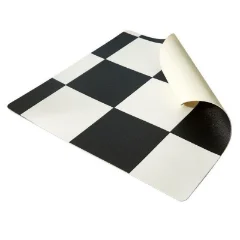 A corner of the black and white Checkerboard Small vinyl rolled back, showing it is sheet material