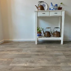 Sanctuary vinyl flooring beneath a white console table holding a brass kettle and storage jars