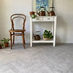 Piazza vinyl flooring with a bentwood chair and white console table holding plants