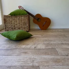 Hlabeni vinyl flooring with a guitar, cushion and woven basket against a white wall