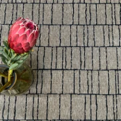 Close-up of the Stacks Almond pattern with a pink protea in a vase