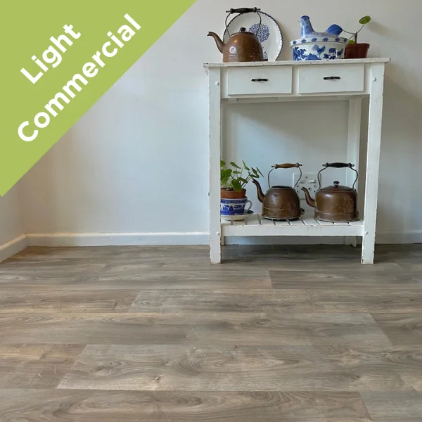 Sanctuary vinyl flooring beneath a white console table with a brass kettle, with a Light Commercial badge