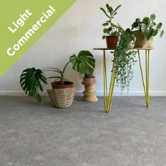 Stonehaven vinyl flooring with potted plants on a yellow hairpin stand, with a Light Commercial badge