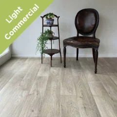 Respite vinyl flooring with a dark timber chair and tiered plant stand, with a Light Commercial badge