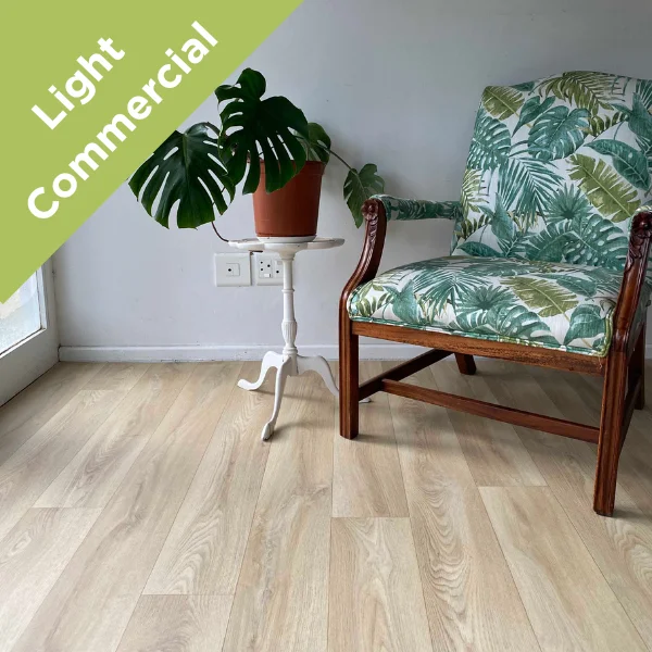 Bliss vinyl flooring beneath two botanical-print armchairs and a monstera in a pale room