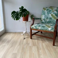 Bliss vinyl flooring beneath two botanical-print armchairs and a monstera, with a Light Commercial badge