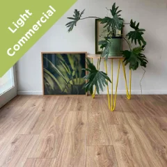 Ember vinyl flooring with yellow hairpin plant stands and framed botanical prints, with a Light Commercial badge