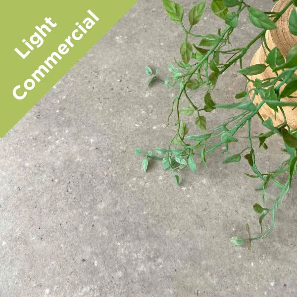 Cornerstone vinyl flooring in mottled grey stone with trailing ivy, with a Light Commercial badge