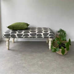 Cornerstone vinyl flooring beneath a striped upholstered bench and potted plants