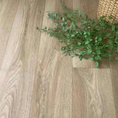 Close-up of Solace pale oak vinyl with eucalyptus stems and a woven basket