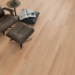 Bare Oak laminate beneath a dark leather lounge chair and ottoman