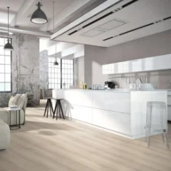Ashen Oak laminate in an open-plan kitchen with a pale island and pendant lighting