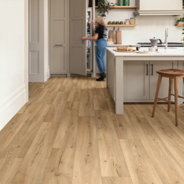 Barley Wood vinyl flooring in a kitchen, with a person standing at the island