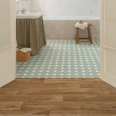 Earth Wood vinyl flooring in a bathroom, meeting a panel of sage-green patterned tile