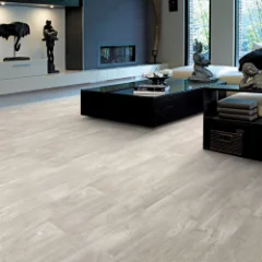 Beach Wood vinyl flooring in a modern lounge with a low dark sofa and coffee table