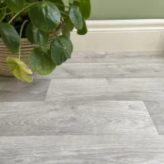 Close-up of Alpine limed-oak vinyl flooring beside a potted plant