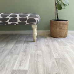 Alpine limed-oak vinyl flooring laid wall to wall in a room with green walls