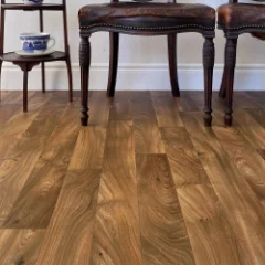 Ambrer honeyed-oak vinyl flooring laid wall to wall in a furnished room