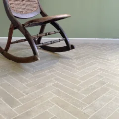 Klompie herringbone brick vinyl flooring laid wall to wall in a furnished room