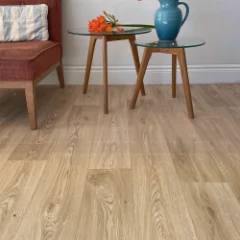Savannah golden-oak vinyl flooring laid wall to wall in a furnished room