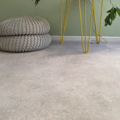 SunStone honed-stone vinyl flooring laid wall to wall in a furnished room