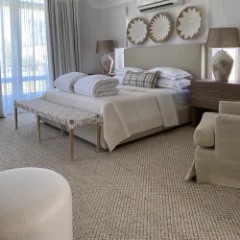 Sisal Heather carpet fitted wall to wall in a bedroom with round mirrors above the bed