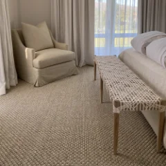 Sisal Heather carpet fitted in a bedroom with a upholstered chair and full-length curtains