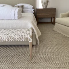 Sisal Heather carpet beneath a timber bench at the foot of a made bed